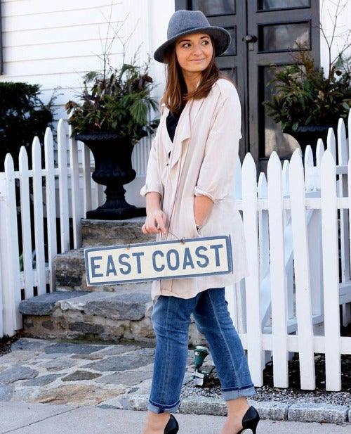 Cute girl holding Weathered Signs East Coast Sign